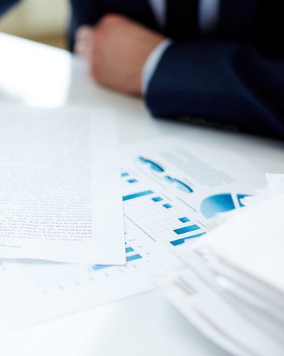 Hand of office worker with pen making notes